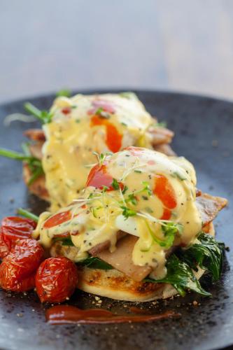a plate of food with cheese and vegetables on it at Cradle Boutique Hotel in Lanseria