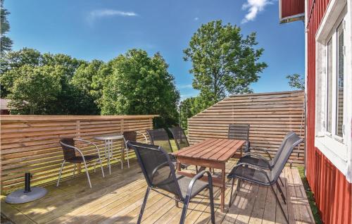 a deck with chairs and a table and a fence at 4 Bedroom Nice Home In Sollebrunn in Sollebrunn
