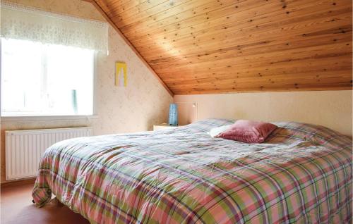 a bedroom with a bed with a wooden ceiling at Lovely Home In Virserum With Wifi in Virserum