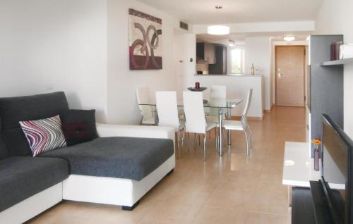 a living room with a couch and a table with chairs at Cozy Apartment In Torre-Pacheco in Los Martínez