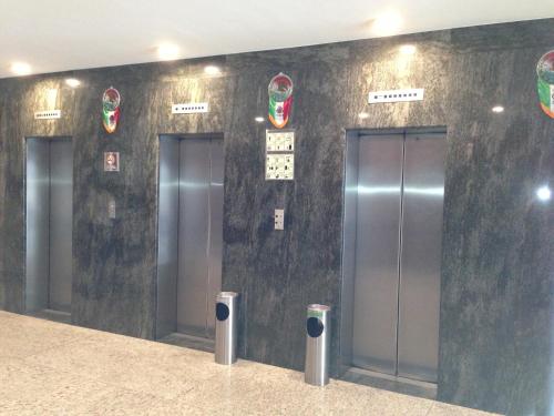a row of elevators in a building with doors at Hotel Amazonas in Mexico City