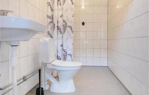 a bathroom with a toilet and a sink at Awesome Apartment In Ystad With 2 Bedrooms And Wifi in Ystad