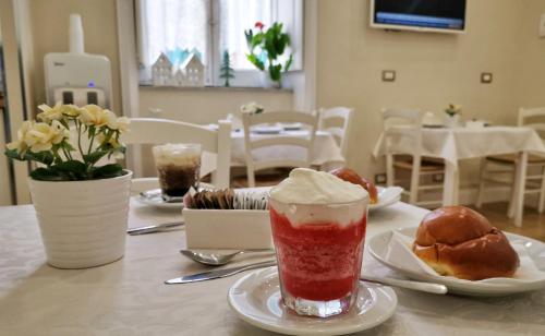 a table with a drink and two pastries on it at Opera Relais in Messina