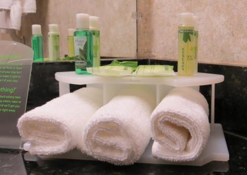 a white shelf with towels on it in a bathroom at Holiday Inn Express & Suites Whitecourt by IHG in Whitecourt