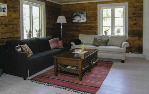 a living room with a couch and a coffee table at Stunning Home In Lidhult With Wifi in Ljushult