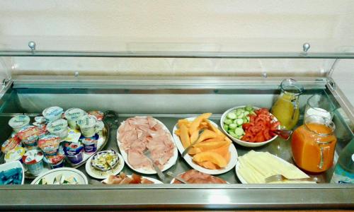 a refrigerator filled with lots of different types of food at Hotel Alessandra in Garda