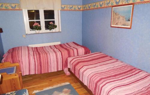 Säng eller sängar i ett rum på Three-Bedroom Holiday home Brösarp with a Fireplace 05