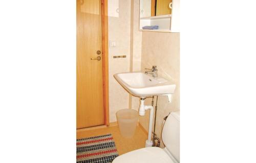 a bathroom with a toilet and a sink at Cozy Home In Gislaved With Lake View in Våthult