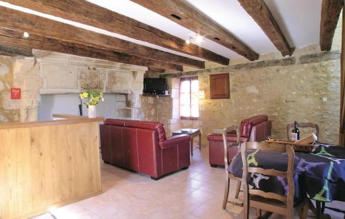 a living room with red chairs and a table at 2 Bedroom Nice Home In Grignols in Grignols Dordogne