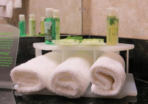 a white shelf with towels on it in a bathroom at Holiday Inn Express Hotel and Suites Lincoln Airport, an IHG Hotel in Lincoln