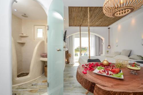 a kitchen and living room with a table with fruit on it at Naxos Island Escape Suites in Plaka