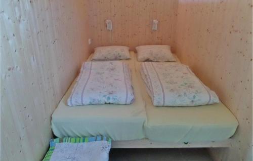 two twin beds in a small room at Nice Studio In Gravdal With Kitchen in Gravdal