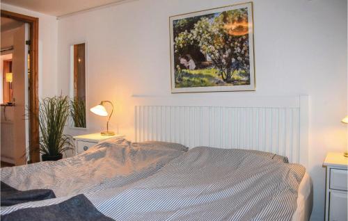 a bedroom with a bed and a painting on the wall at Cozy Home In Höllviken With Wifi in Höllviken
