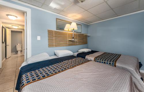 a bedroom with two beds in a room at Boardwalk Hotel Charlee & Apartments Beach Hotel Oceanfront in Seaside Heights
