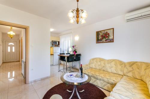 a living room with a couch and a table at Apartmani Katica in Povile