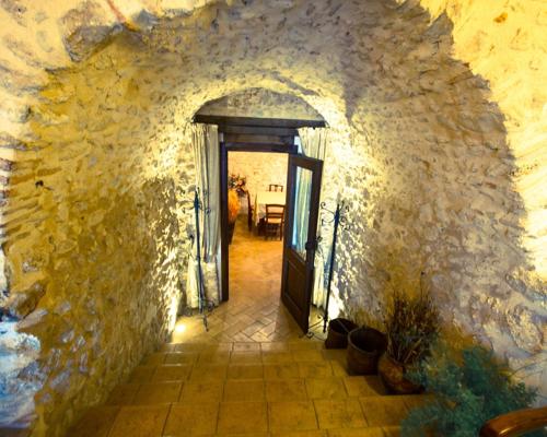 a hallway with a door in a stone wall at Agriturismo Il Casale Degli Amici in Norcia