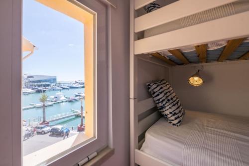 a bedroom with a bunk bed with a view of a harbor at LovelyStay - Two Bedroom Duplex at Vilamoura Marina in Vilamoura