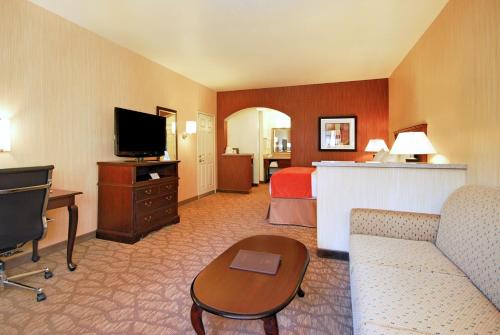 a large hotel room with a bed and a television at Best Western San Dimas Hotel & Suites in San Dimas