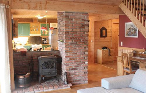 a living room with a brick fireplace in a house at Amazing Home In Farsund With House Sea View in Lindland