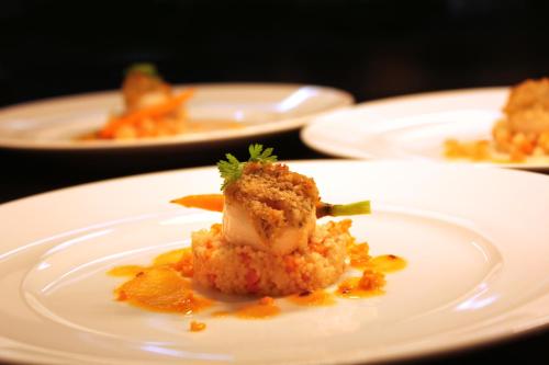 a white plate with a piece of food on it at Hotel Restaurant Am Kring in Vreden