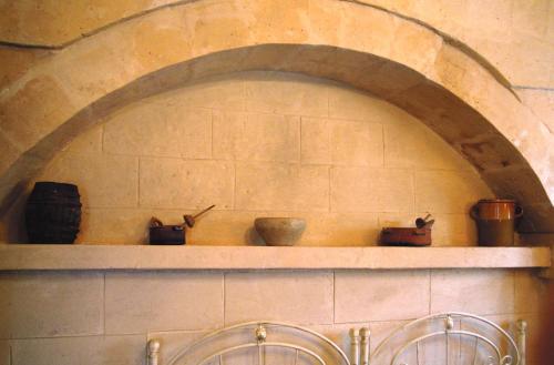 a shelf with bowls and utensils on a wall at Casa Contini in Matera