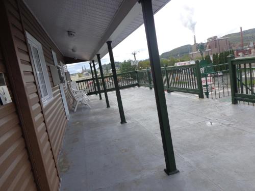 a porch of a building with a bench on it at Happy Motel in Edmundston