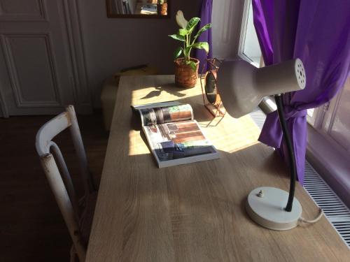 a table with a lamp and a book on it at Zen Hostel by Central Market in Budapest