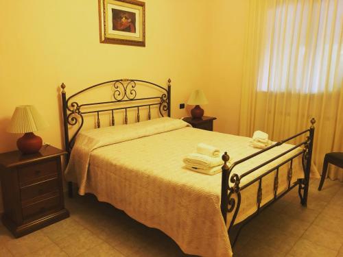 a bedroom with a bed with towels on it at Villa Patrizia-Luxury Villa in Mottola