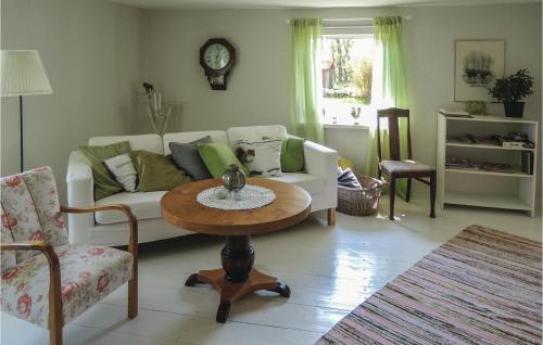 a living room with a couch and a table at Three-Bedroom Holiday Home In Stromsnasbruk in Grysshult