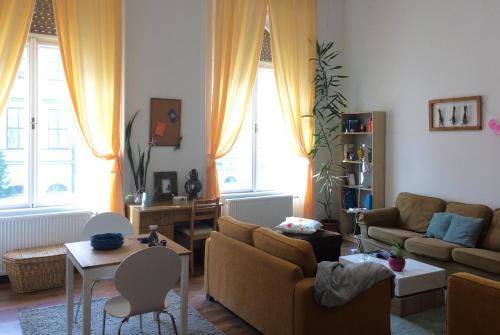 a living room filled with furniture and a window at Zen Hostel by Central Market in Budapest