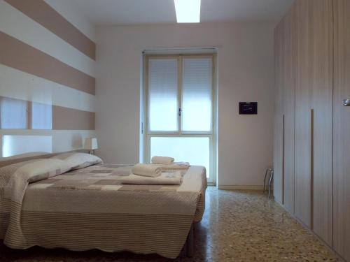 1 dormitorio con 1 cama con toallas en Lacaralele Apartment, en Milán