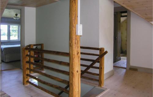 a staircase in a house with a wooden railing at Stunning Home In Lidhult With Wifi in Ljushult