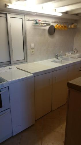 a kitchen with two sinks and a counter top at La villa des fleurs in Lamalou-les-Bains