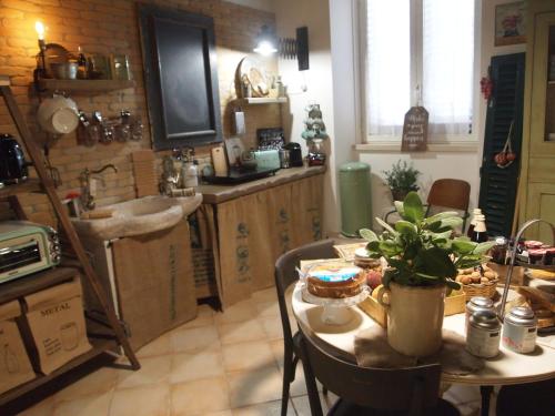 a kitchen with a table and a sink at Bernardiniani Apartment in Molfetta