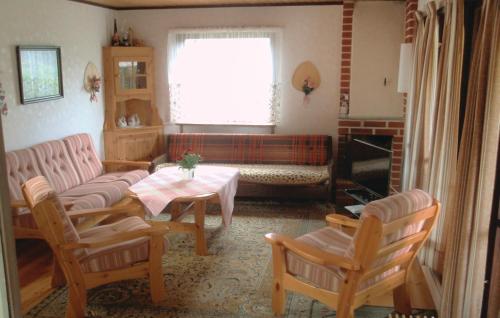a living room with a couch and a table and chairs at Two-Bedroom Holiday Home In Solvesborg in Sölvesborg
