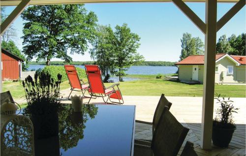 two chairs and a table with a view of the water at Amazing Home In Bolmsö in Bolmsö