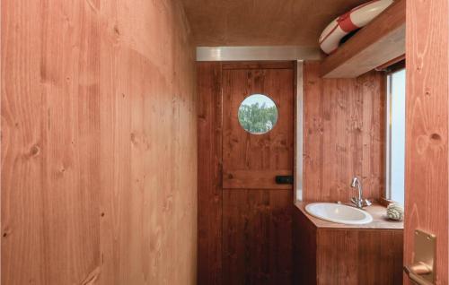 a bathroom with a sink and a wooden wall at Nice Ship In Neustrelitz With House Sea View in Neustrelitz