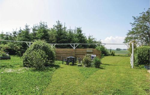 a garden with a wooden fence and a picnic table at Two-Bedroom Holiday Home In Ystad in Ystad