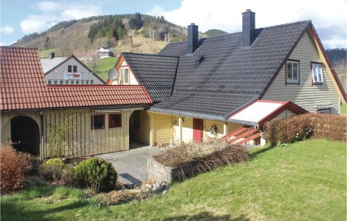 a house with a red roof on a hill at 5 Bedroom Lovely Home In Seim in Seim