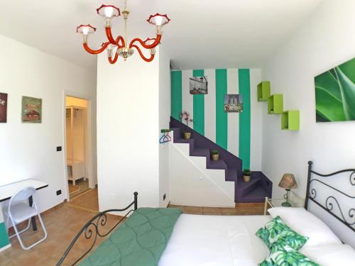 a living room with a chandelier and a staircase at Il Giardino Del Nespolo in Arcola