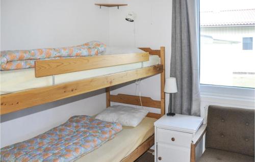 two bunk beds in a room with a window at Cozy Home In motsfors With Kitchen in Gryttved