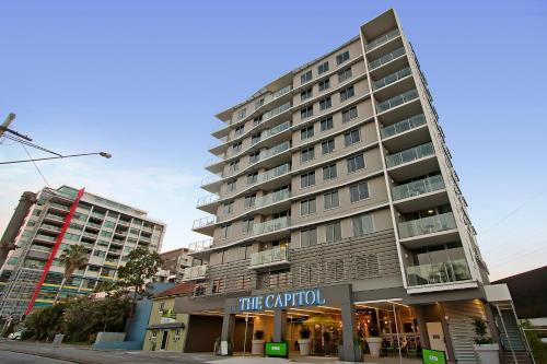 a tall building on a city street with a hotel at The Capitol Apartments in Brisbane