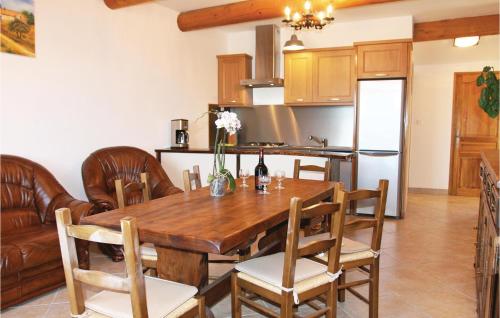 une cuisine et une salle à manger avec une table et des chaises en bois dans l'établissement 2 Bedroom Awesome Home In Sigoyer, à Sigoyer