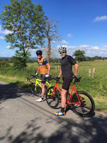 two men standing next to their bikes on a road at ZONE BLEUE in Hyds