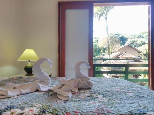 En eller flere senge i et værelse på Villa Félix Suites e Chalés
