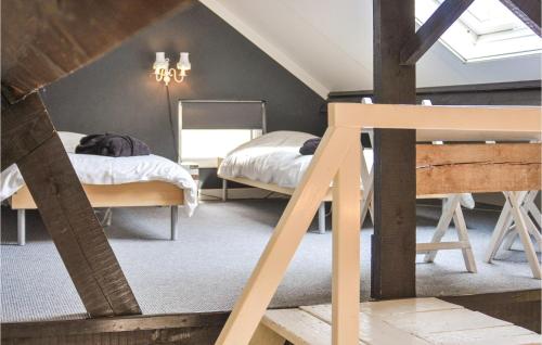 a attic bedroom with two beds and a mirror at Beautiful Home In Leende With Wifi in Leende