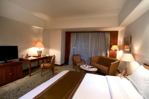 Ένα ή περισσότερα κρεβάτια σε δωμάτιο στο The Sultan Hotel & Residence Jakarta