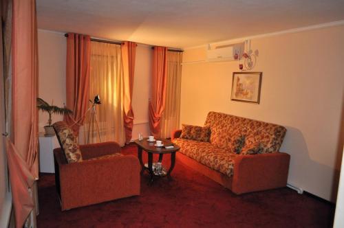 a living room with a couch and two chairs at Family hotel on the lake Lakada in Gribki