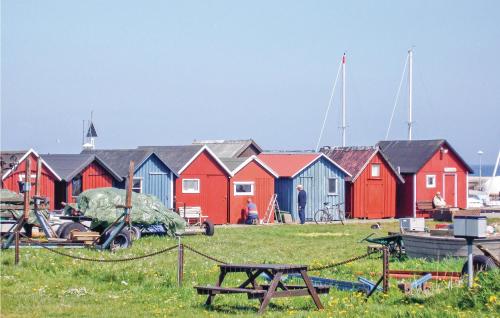 a group of brightly colored houses in a field at Holiday Home Fiskarevägen Abbekås Ii in Abbekås