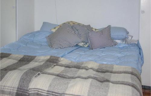 a bed with pillows and a blanket on it at Nice Home In Ystad With 2 Bedrooms And Internet in Ystad